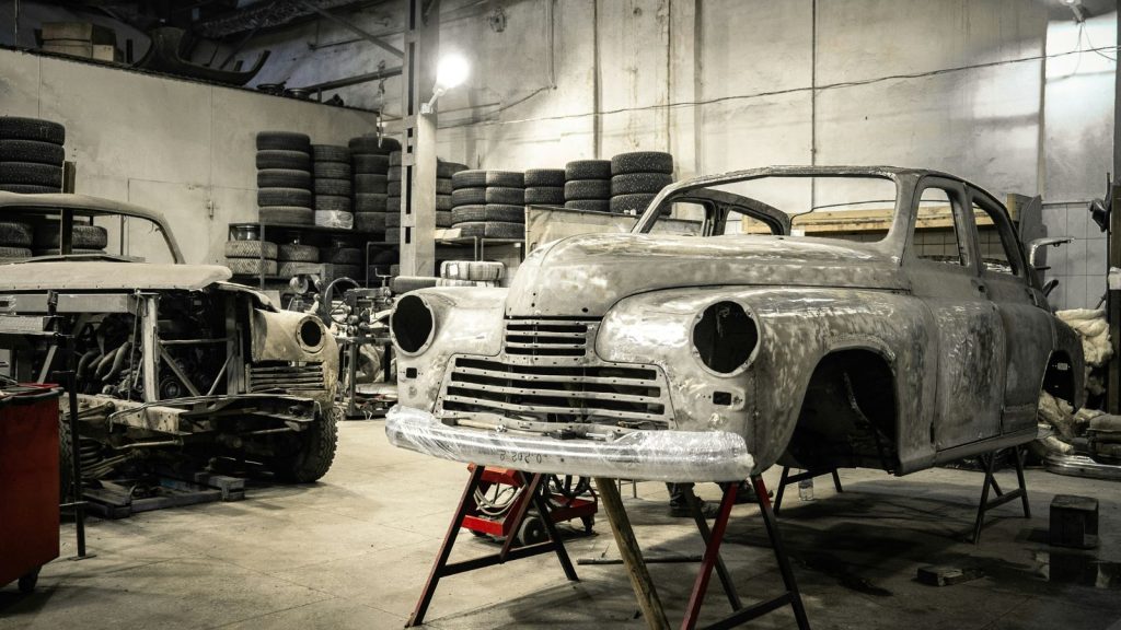 Restoring old cars in a garage.