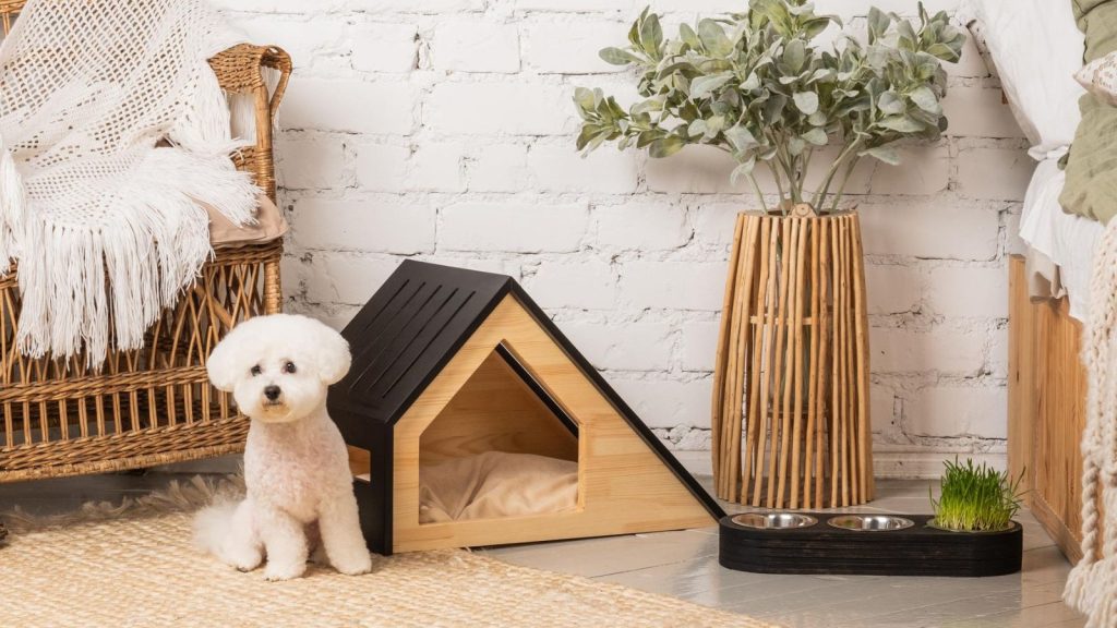 a dog beside the dog house or bed with water and food bowl in the pet nook