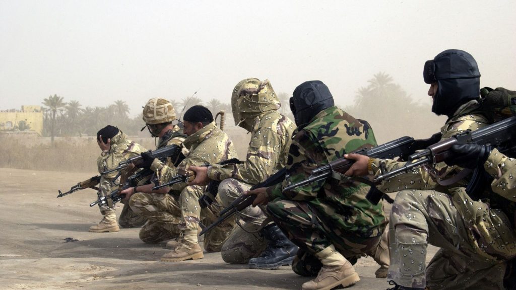 Iraqi Army (NIA) Soldiers and a British Army Soldier in a line