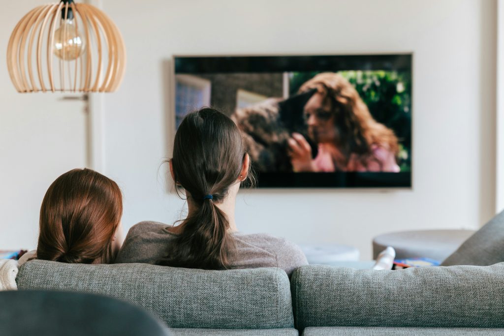 two woman watching tv together